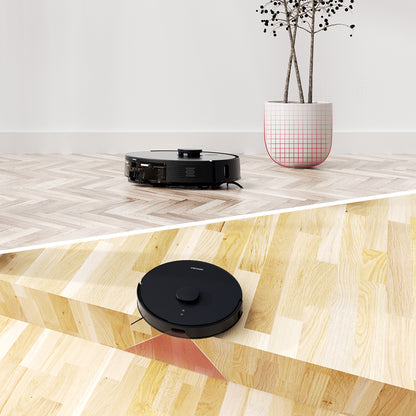 AIRROBO robot vacuum cleaner shown on wooden and herringbone floors with decorative potted plant in minimalist setting